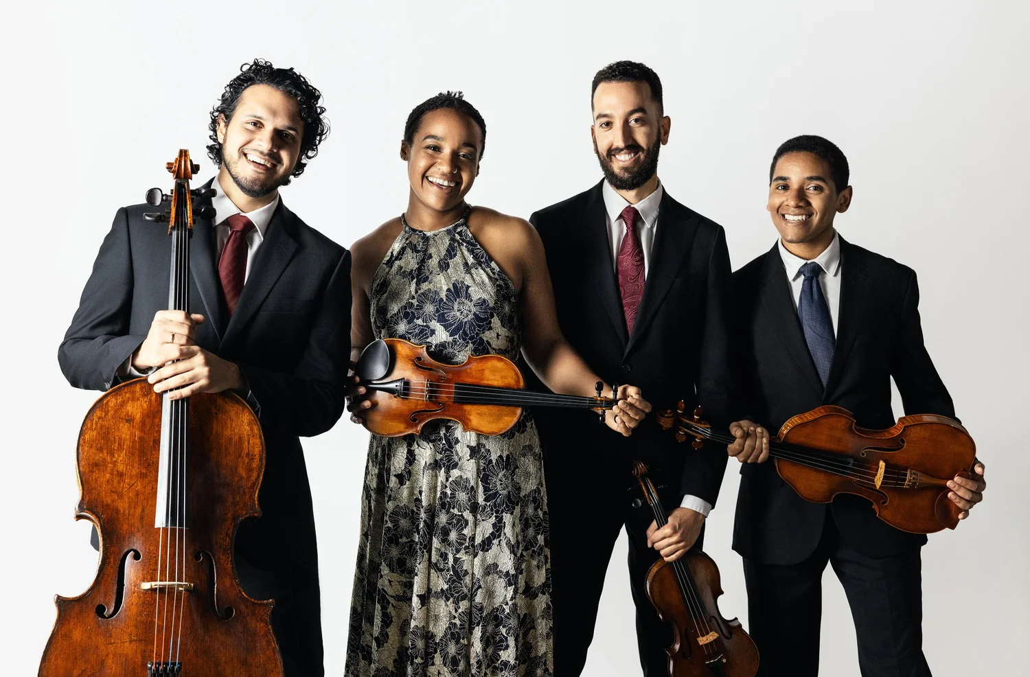 The Ivalas Quartet holding a variety of string orchestra instruments.
